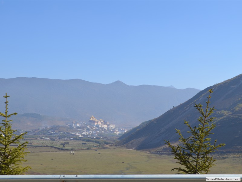 A mountain monastery visible in the distance.